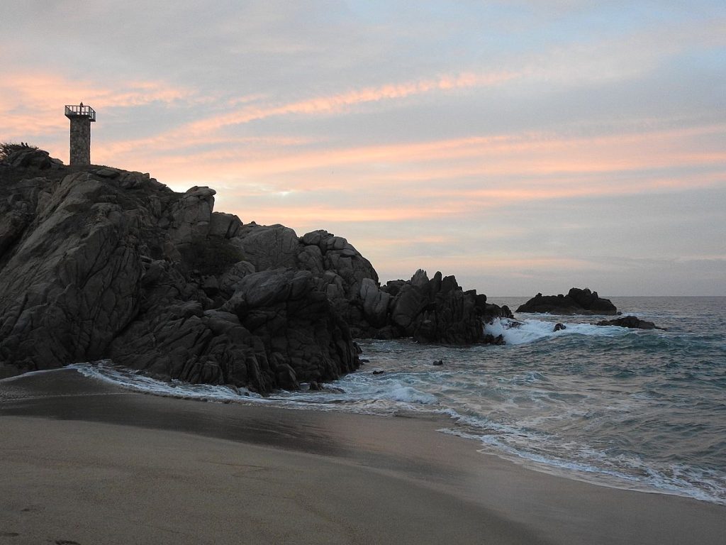 The lighthouse on its point of rocks.